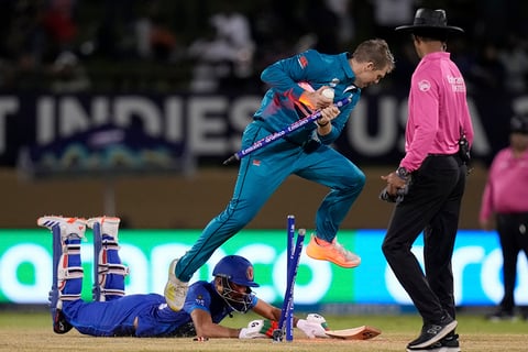 Lockie Ferguson jumps over Ibrahim Zadran